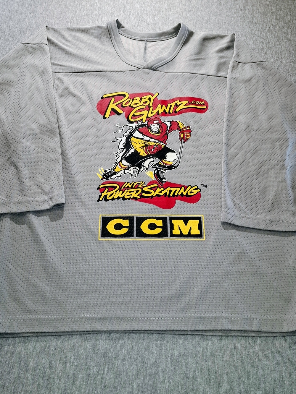 Vintage CCM Gray Hockey Jersey with Red & Yellow Graphic